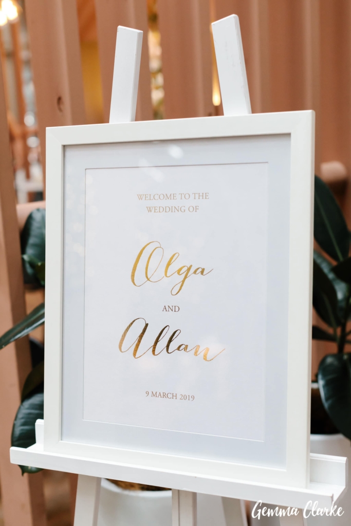 Gold foiled wedding welcome sign, set in a white frame with matching white timber easel. Image Gemma Clarke.