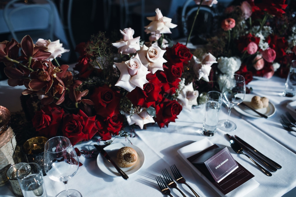 Beautiful florals adorn the tables for this wedding by Petal and Fern. Image Fiona + Bobby.