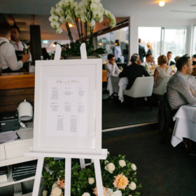 A3 Gold foiled seating chart in white frame with matching white easel. Image Gemma Clarke.