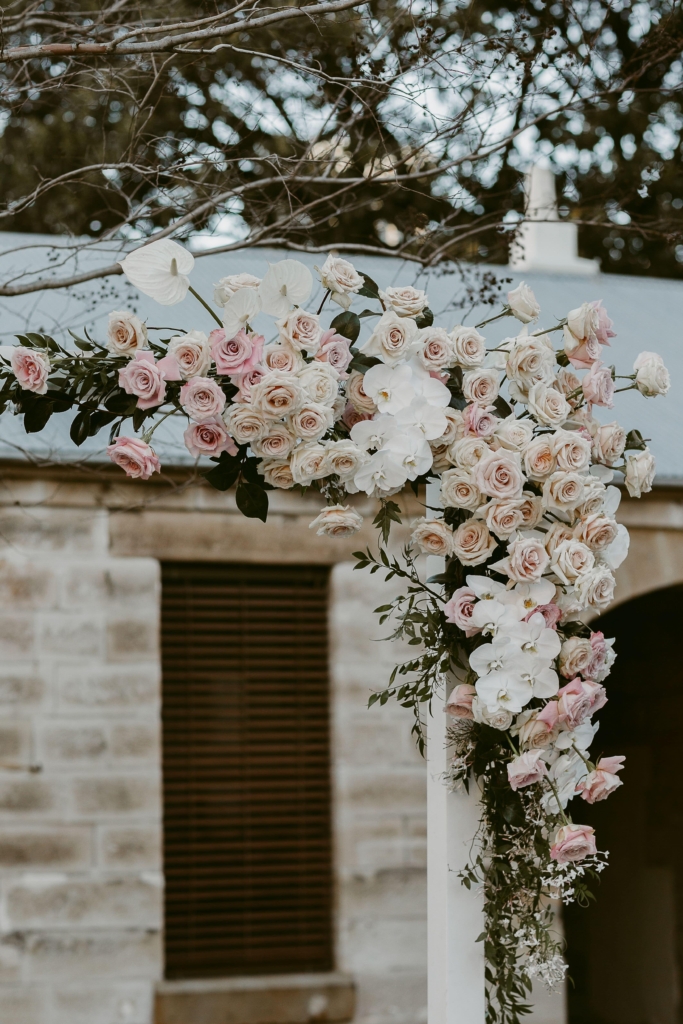 Roses and orchids on wedding arch