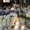 Candles and floral wedding centrepiece The Stables